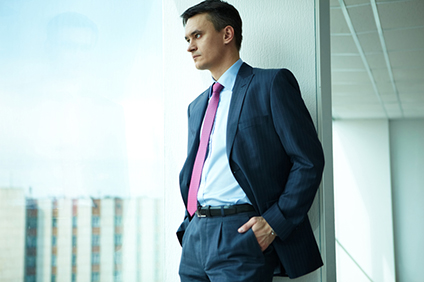 Wilde Success, Business Coach, Business Coaching, Carmen Wilde, Gary Wilde man looking through window in office